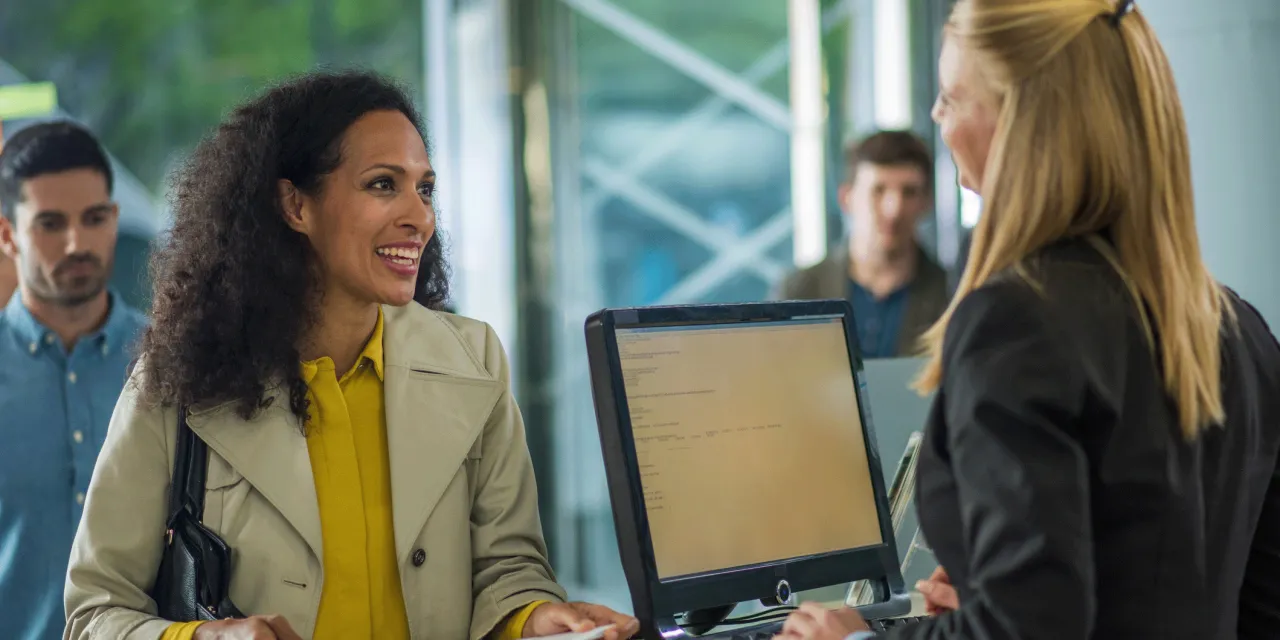 Person talking to receptionist.