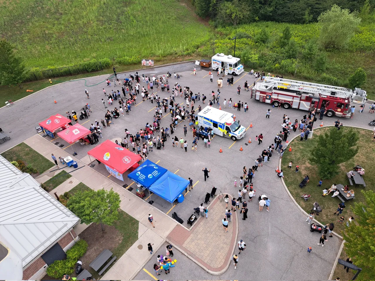 an aerial view of the fire station open house showing people at the event