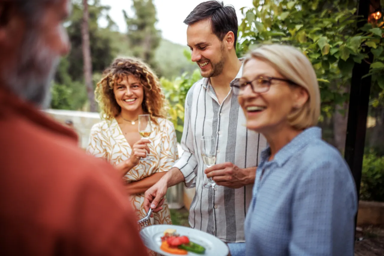 Group of people smiling at an outdoor event.