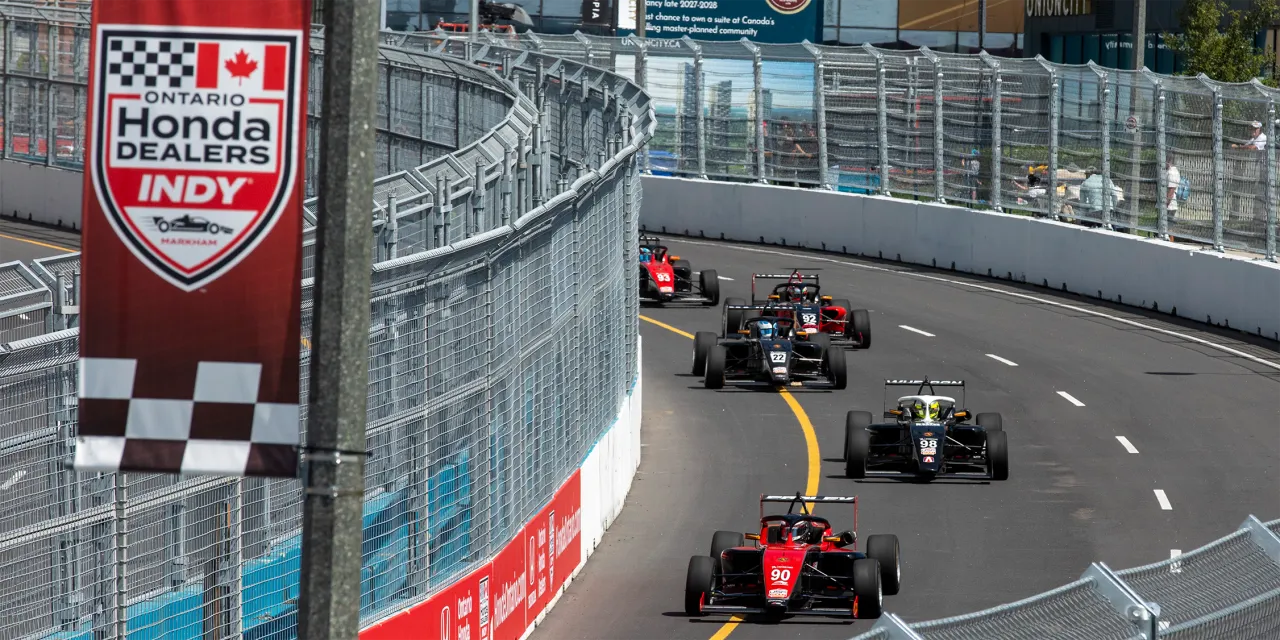 Cars racing on Markham street during 2026 Honda Dealers Indy at Markham event.