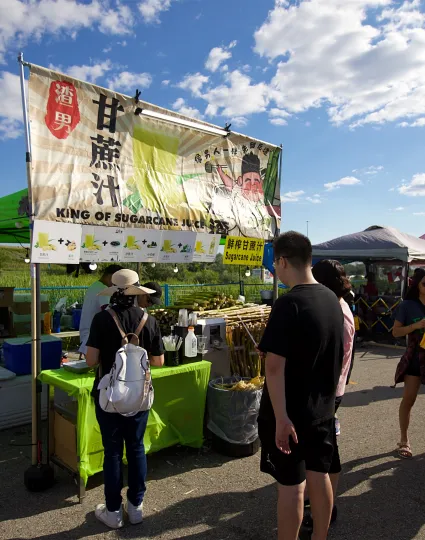 People in line at food stand.