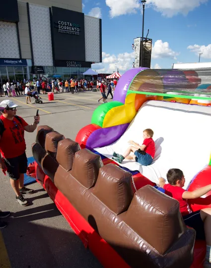 Children on an inflatable slide.