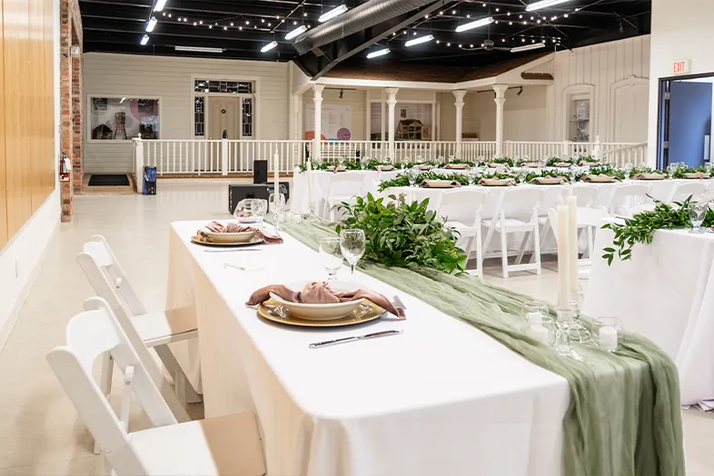 Indoor space with tables and plates displayed.