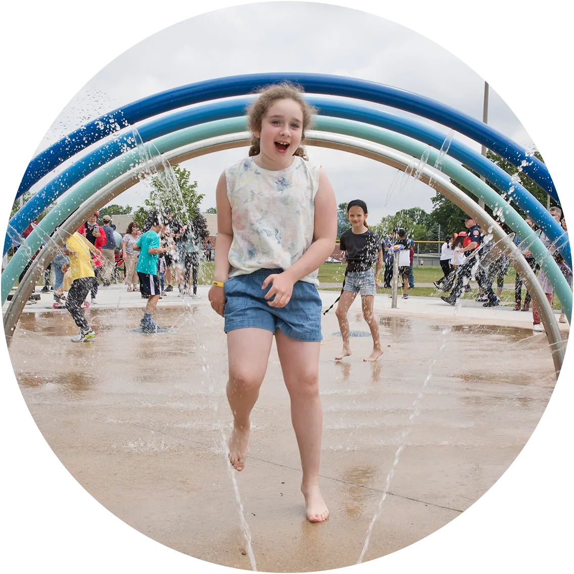 Child playing in a City operated splashpad.